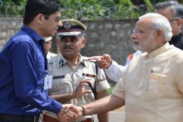 Bastar collector warned for wearing sunglasses while receiving PM Modi